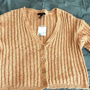 Pinkish sweater cardigan style.